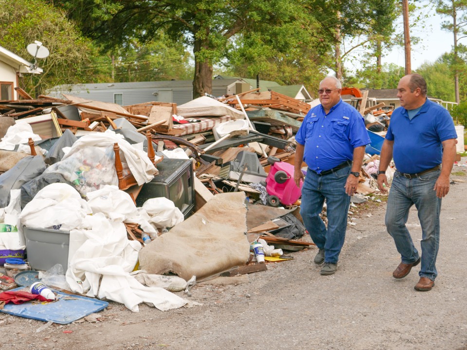 Walking past storm debris after a hurricane