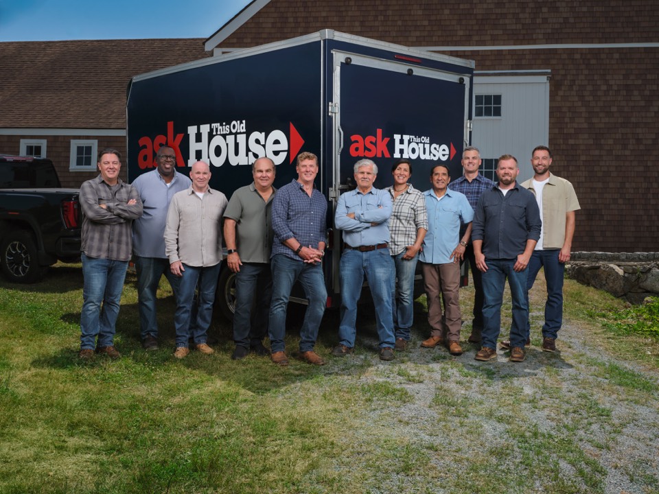 The full Ask This Old House team in front of the trailer